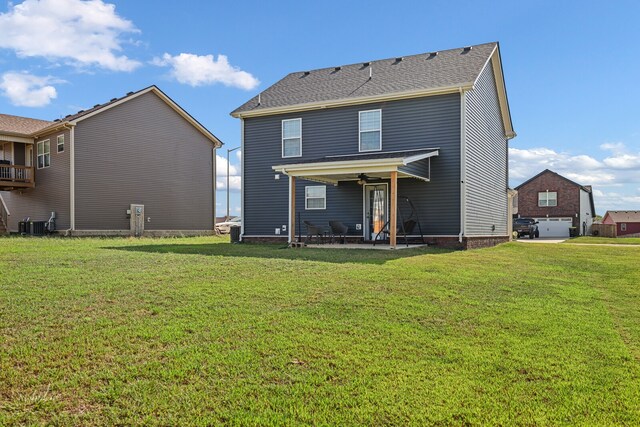 rear view of property featuring a patio area and a yard