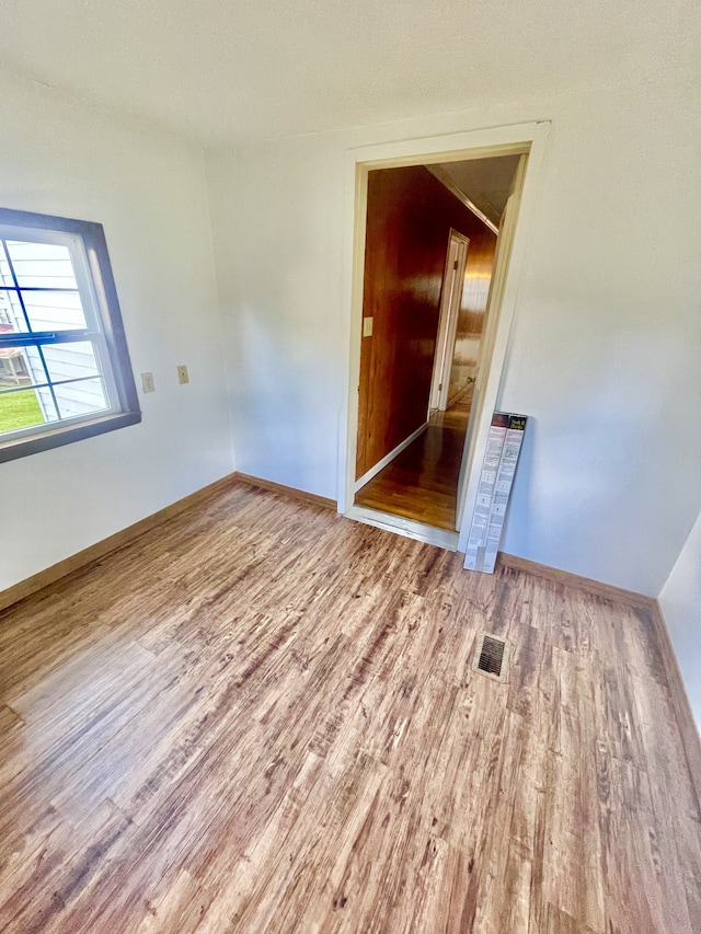 spare room with wood-type flooring