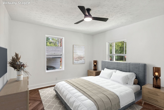 bedroom featuring ceiling fan and a textured ceiling