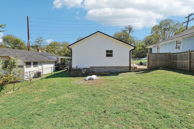 back of property featuring central AC unit and a yard