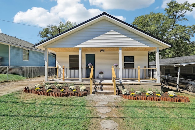 bungalow-style home featuring a front lawn and covered porch