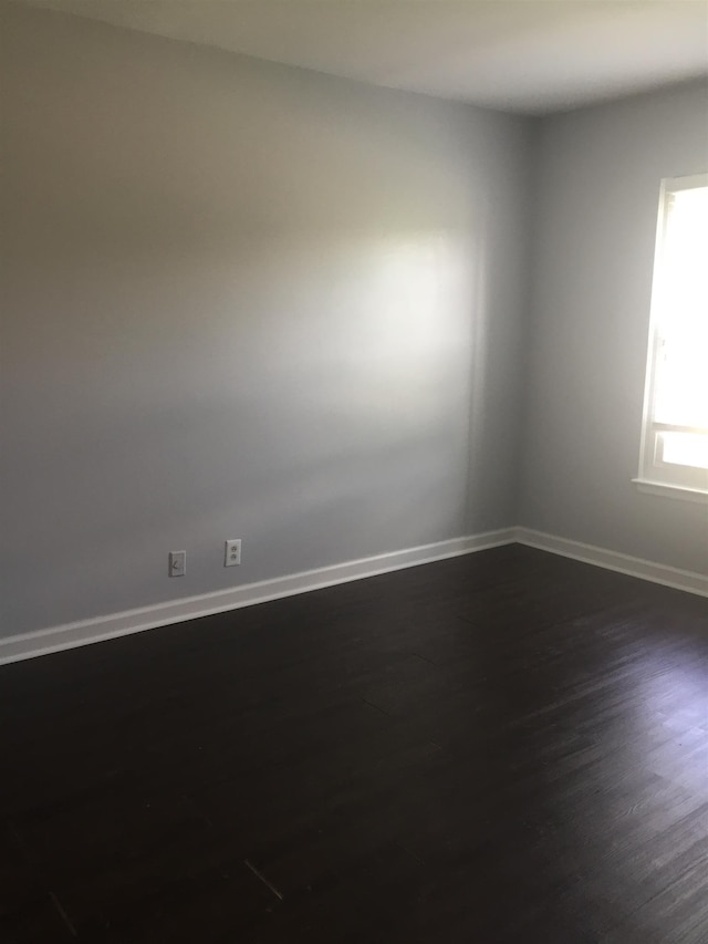 spare room featuring dark hardwood / wood-style floors