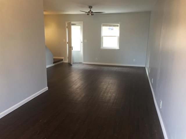 unfurnished room featuring ceiling fan and dark hardwood / wood-style flooring