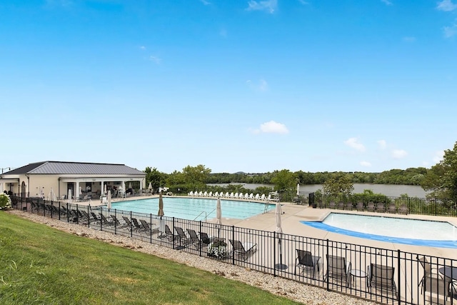 view of pool featuring a water view and a patio area