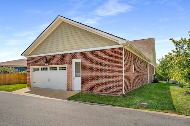 view of side of property with a yard and a garage