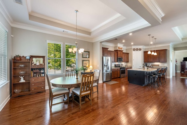 dining area with an inviting chandelier, crown molding, dark hardwood / wood-style floors, and a raised ceiling