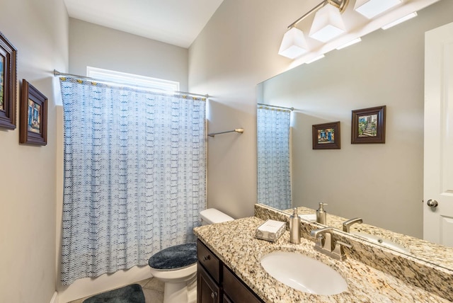 bathroom with tile patterned floors, vanity, and toilet