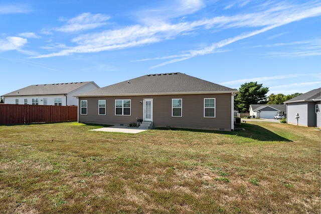 rear view of house with a yard and a patio area