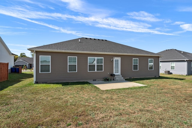 rear view of house with central AC unit, a lawn, and a patio area