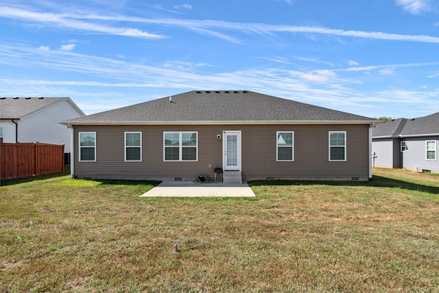 rear view of house with a patio and a lawn