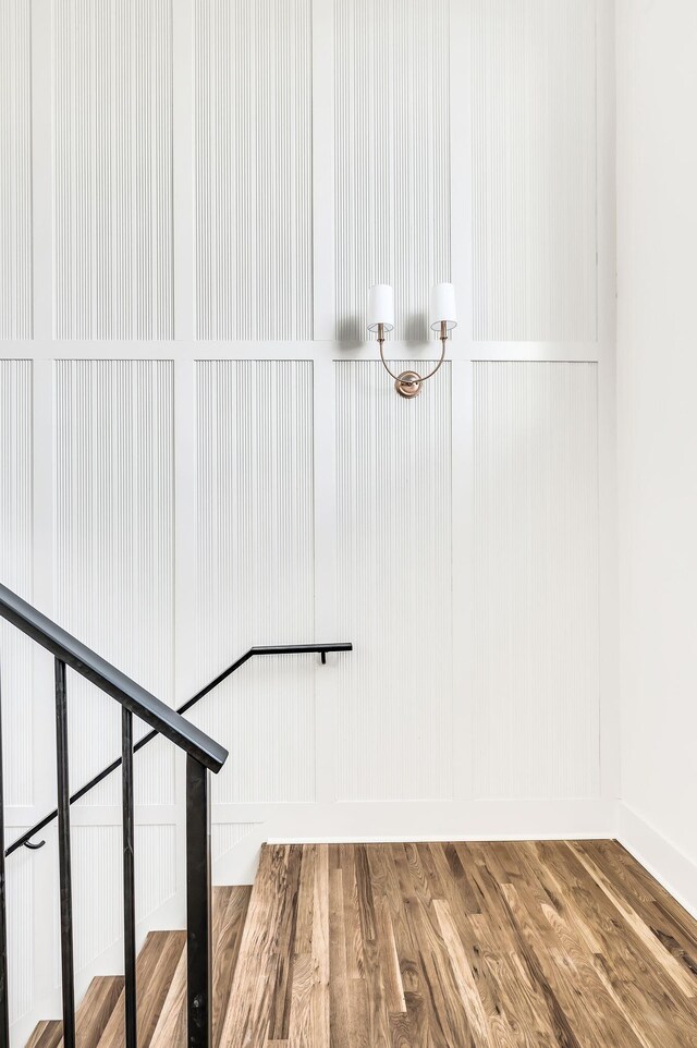 staircase with hardwood / wood-style floors