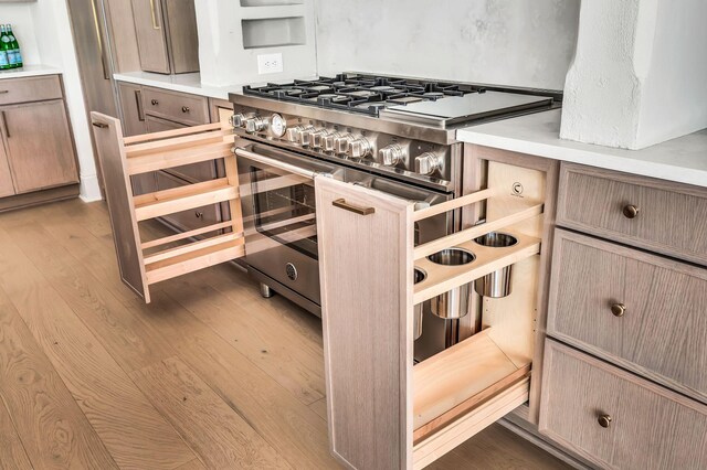 kitchen with range with two ovens and hardwood / wood-style floors