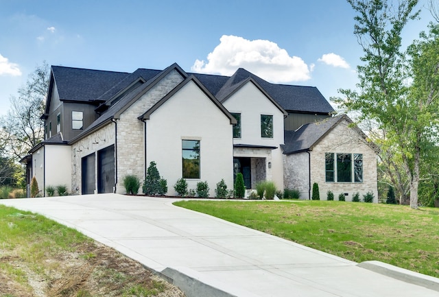 french country inspired facade featuring a garage and a front yard