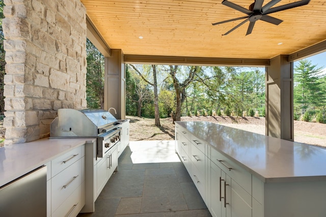 view of patio / terrace with ceiling fan, an outdoor kitchen, and grilling area