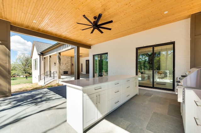 view of patio / terrace featuring ceiling fan and an outdoor kitchen