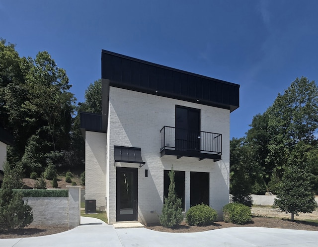 view of front facade with a balcony and central AC unit