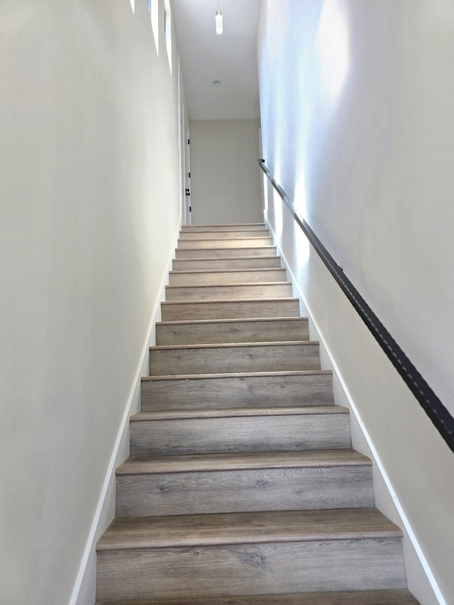 stairs with hardwood / wood-style flooring