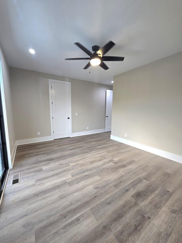 spare room featuring ceiling fan and light hardwood / wood-style floors