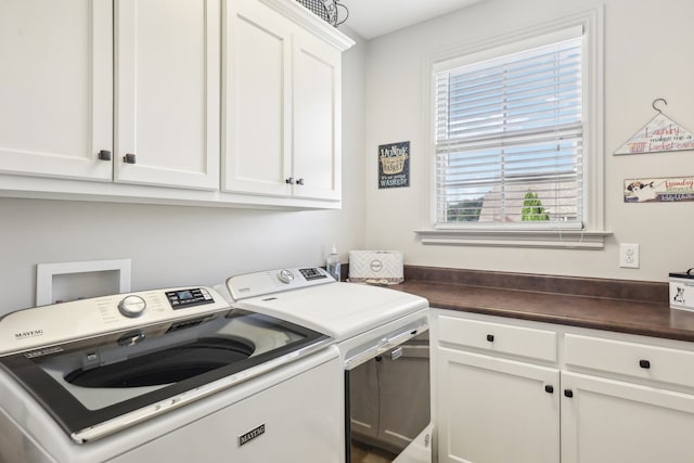 laundry room featuring cabinets and washing machine and dryer