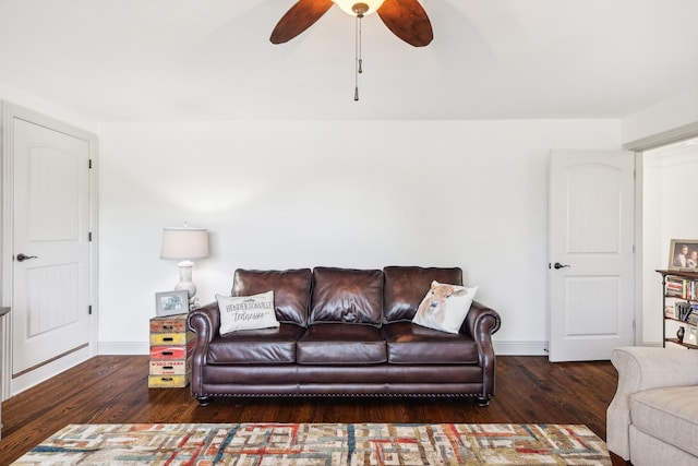 living room with ceiling fan and dark hardwood / wood-style floors