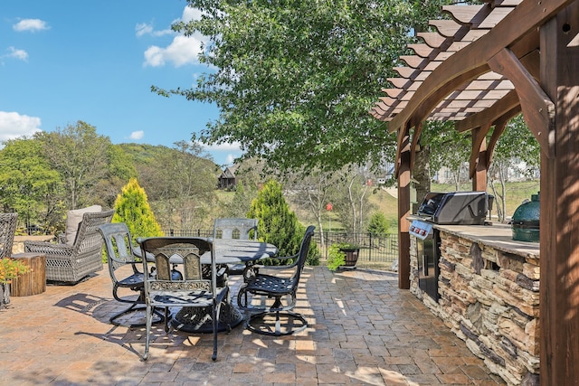 view of patio / terrace featuring a pergola, area for grilling, and an outdoor kitchen