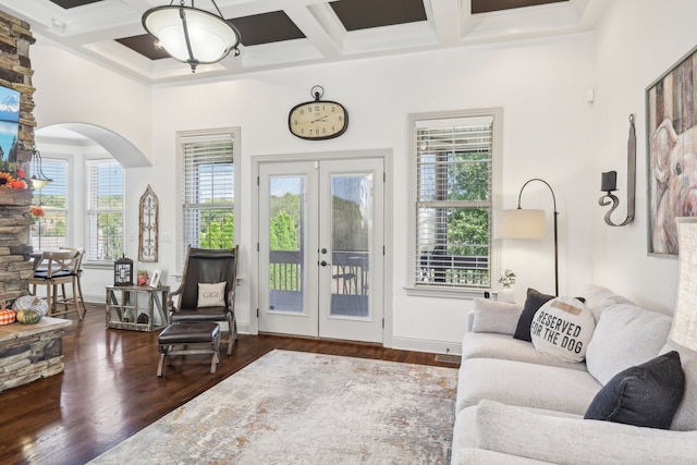 living room with a wealth of natural light, coffered ceiling, and dark hardwood / wood-style floors