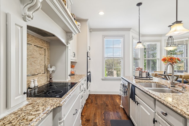 kitchen with black electric cooktop, sink, white cabinetry, decorative light fixtures, and dark hardwood / wood-style flooring