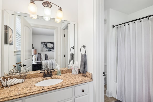 bathroom with walk in shower and vanity