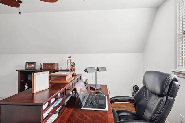 home office with vaulted ceiling, dark wood-type flooring, and ceiling fan