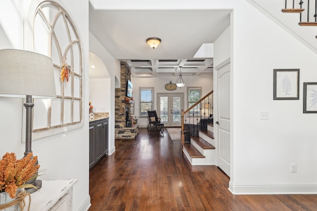 entryway with french doors, beamed ceiling, dark wood-type flooring, and coffered ceiling