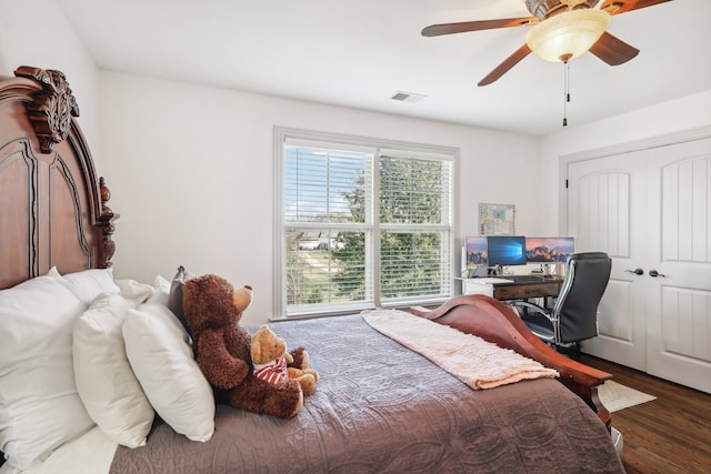 bedroom with ceiling fan, a closet, and dark hardwood / wood-style floors