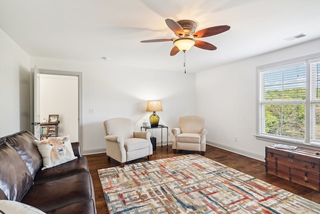 living room with ceiling fan and dark hardwood / wood-style floors