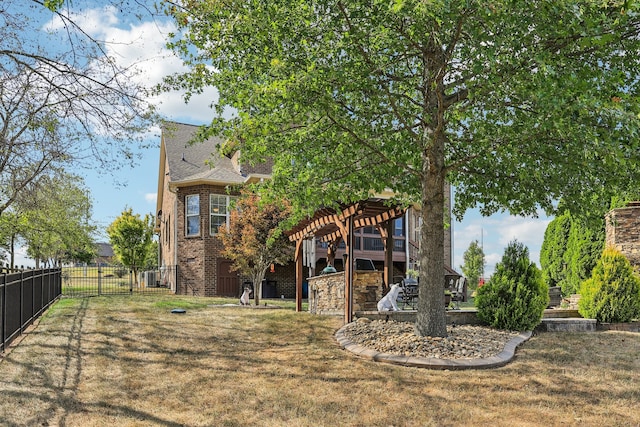 rear view of property featuring a pergola and a lawn