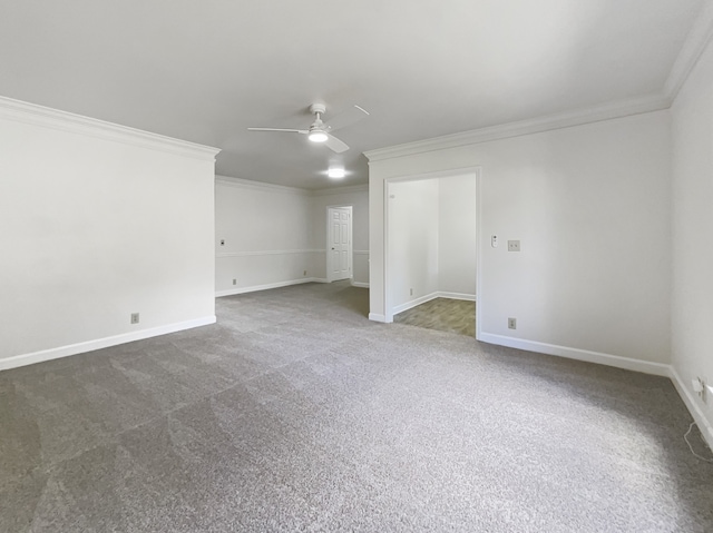 carpeted spare room featuring crown molding and ceiling fan