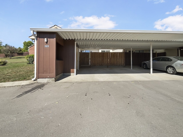 view of car parking featuring a lawn and a carport