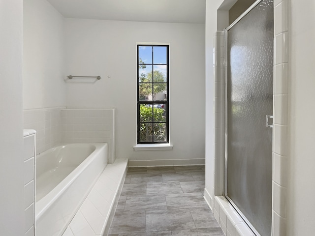 bathroom featuring independent shower and bath