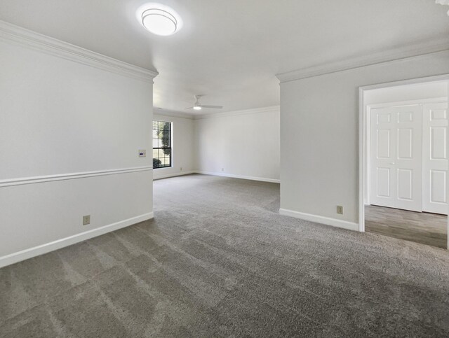 unfurnished room featuring dark colored carpet, ceiling fan, and crown molding