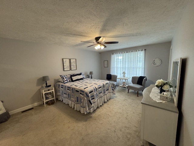 bedroom with carpet floors, a textured ceiling, and ceiling fan