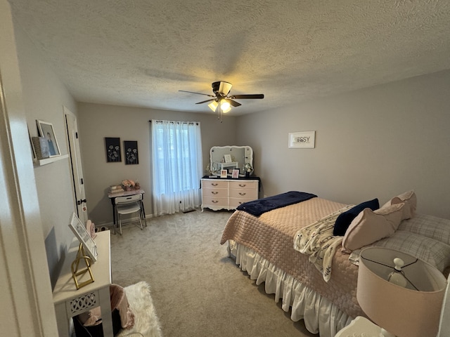 carpeted bedroom with a textured ceiling and ceiling fan