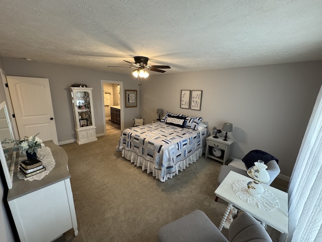 bedroom with a textured ceiling, connected bathroom, dark carpet, and ceiling fan