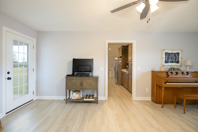 living room featuring light hardwood / wood-style floors and ceiling fan