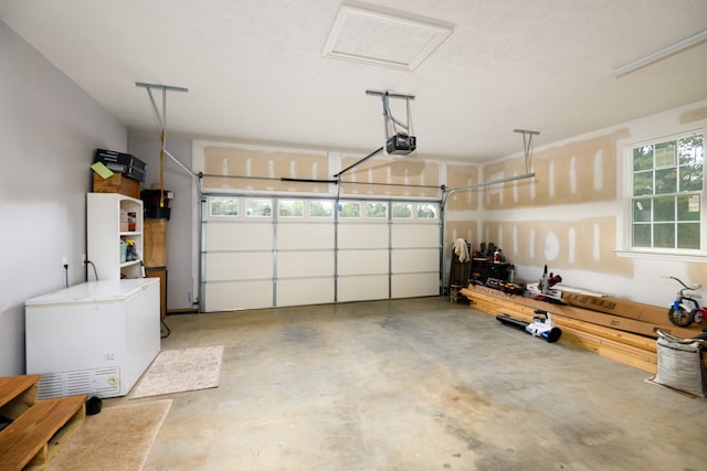 garage with fridge and a garage door opener