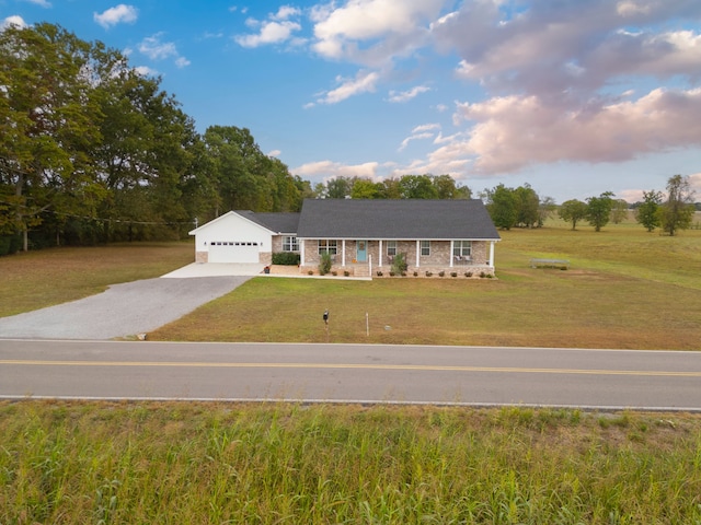 ranch-style home with a front yard and a garage