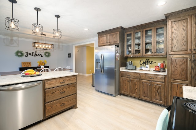 kitchen featuring dark brown cabinetry, hanging light fixtures, ornamental molding, appliances with stainless steel finishes, and light wood-type flooring