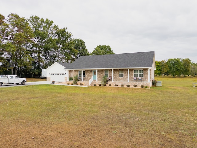 ranch-style house featuring a front lawn and a garage