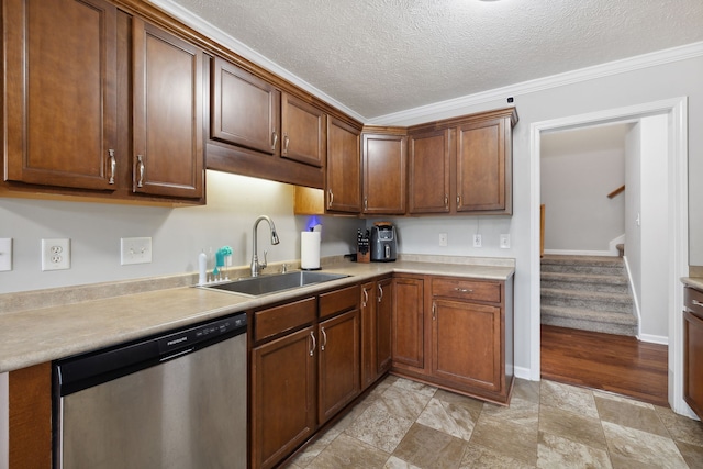 kitchen with ornamental molding, dishwasher, sink, and a textured ceiling