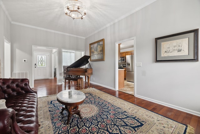 interior space with ornamental molding, an inviting chandelier, and dark wood-type flooring