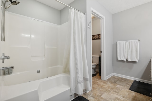 bathroom with toilet and shower / bath combo with shower curtain