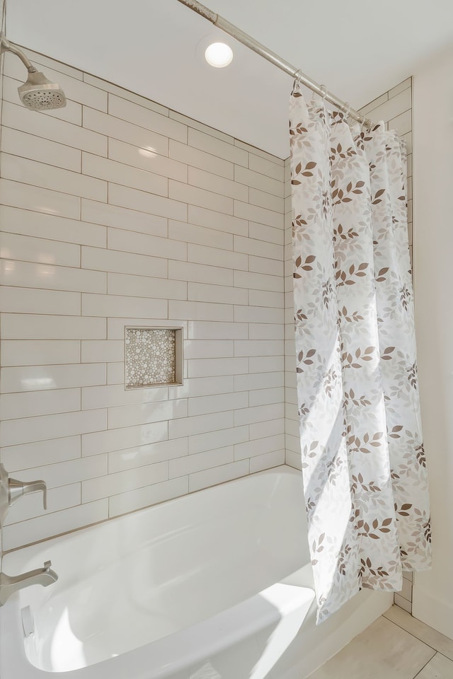 bathroom with shower / tub combo with curtain and tile patterned flooring