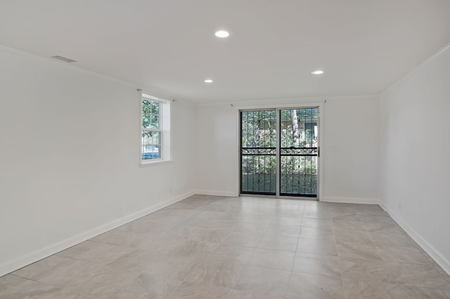 spare room with crown molding and a healthy amount of sunlight